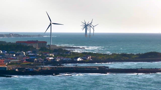 Coastal wind turbines and village view