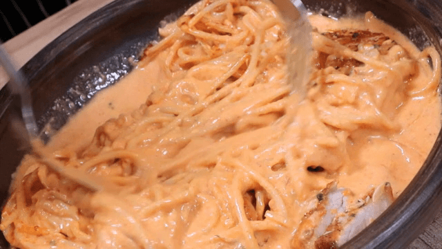 Mixing Pork and Red Chili Paste Cream Pasta