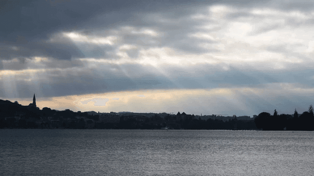 Cloudy sky over calm river and landscape
