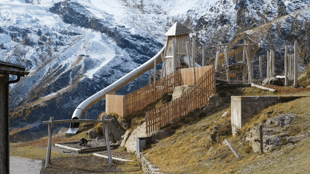Snow-covered mountain and playground with children playing