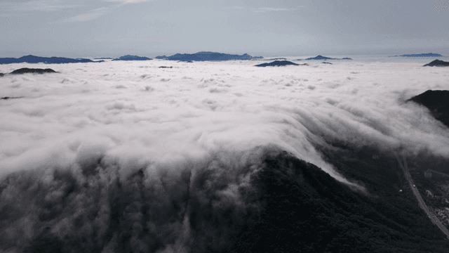 Clouds cascading over mountain peaks