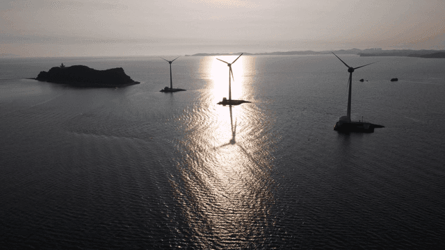 Wind turbines on sunlit sea