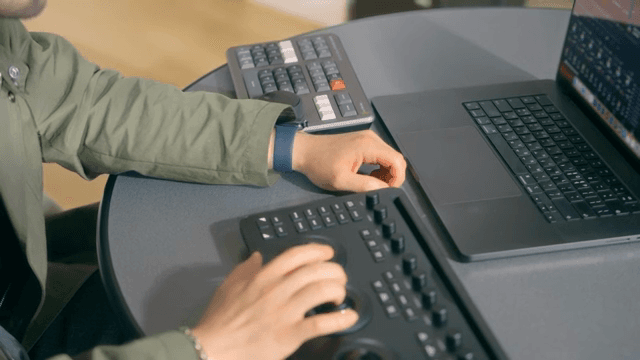 Hands operating a video editing console