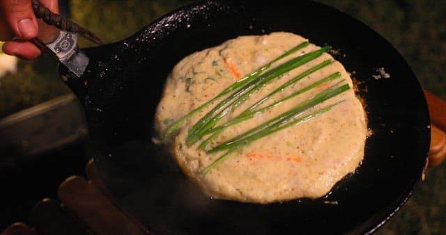 Preparing Savory Korean pancake on a Hot Skillet