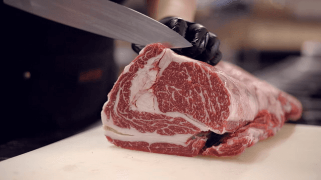 Slicing raw meat on a cutting board