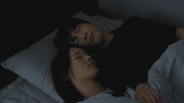 Couple sleeping peacefully in bed