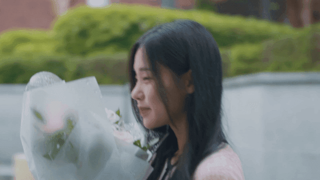 Woman smiling with a bouquet of flowers
