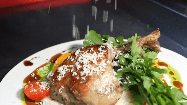 Duck confit with grated cheese