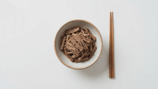 Shredded beef braised in soy sauce served with chopsticks
