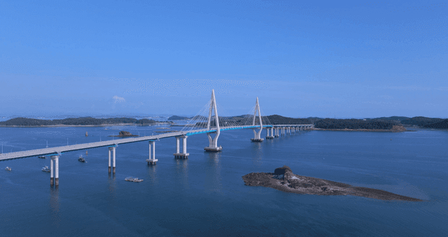 Long bridge over calm blue sea