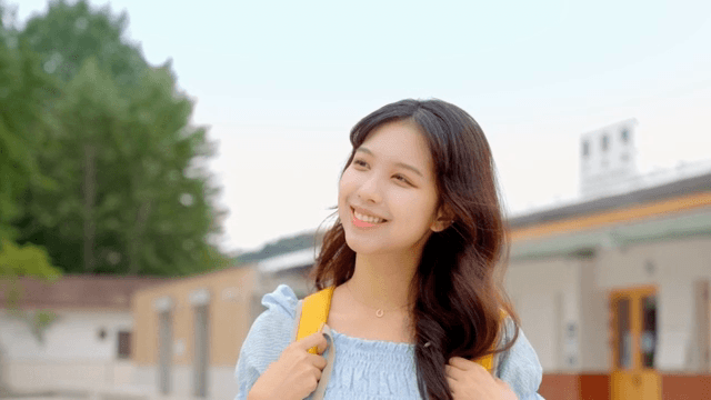 A young woman smiling outdoors