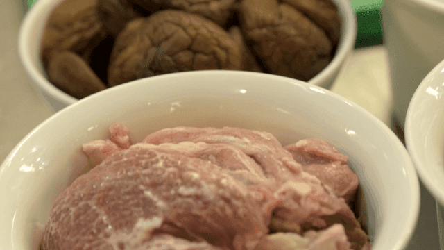 Raw meat and mushrooms in bowls