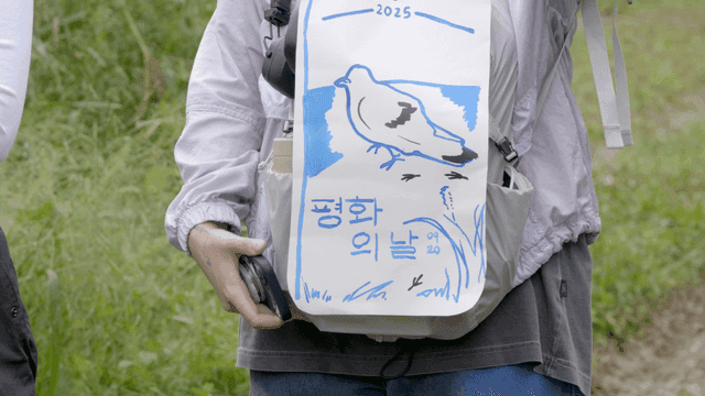 Person holding bag with dove drawing on Peace Day