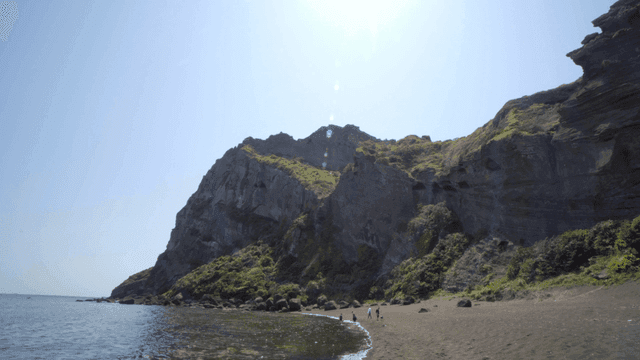 Rocky beach with towering cliffs
