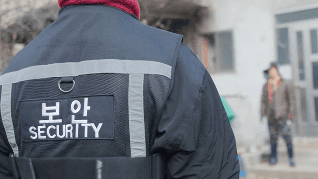 Security guard standing outside a building