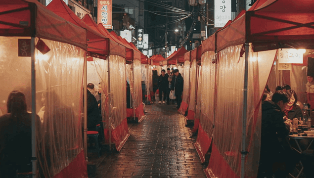 Street food stall tents bustling with people