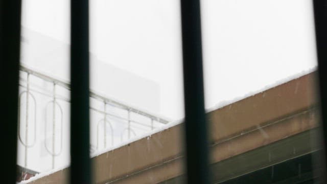 Snowflakes falling on a balcony on a snowy winter day