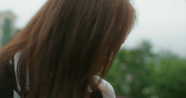 Schoolgirl taking medicine with water outdoors