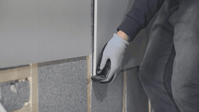 Worker installing insulation panels