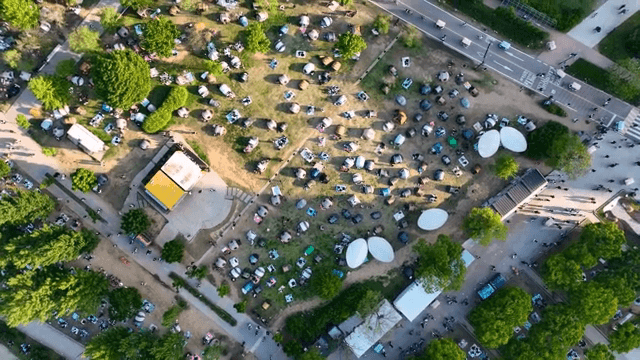 Park filled with tents and people enjoying