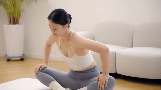 Woman stretching indoors