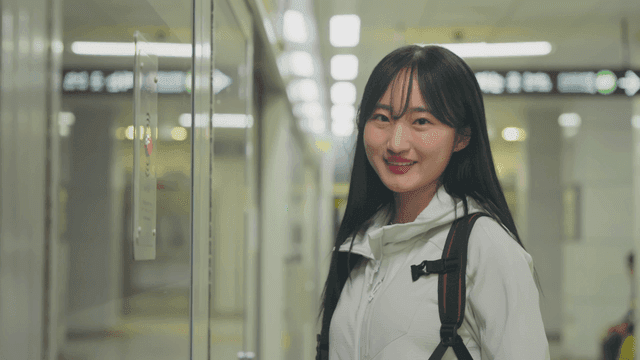 Smiling woman waiting on subway platform