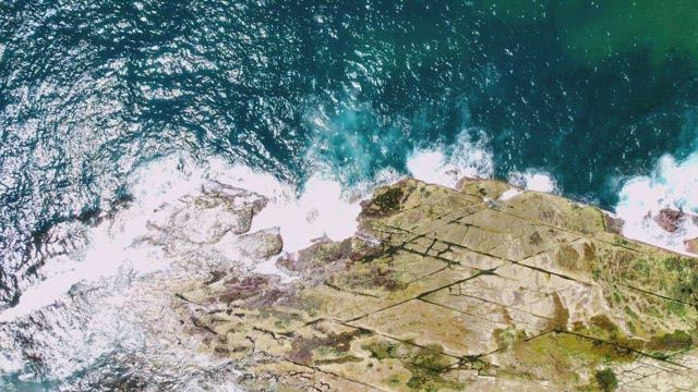 Sea Waves Crashing Against Rocky Shore