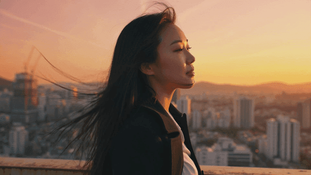 Working woman enjoying sunset on rooftop