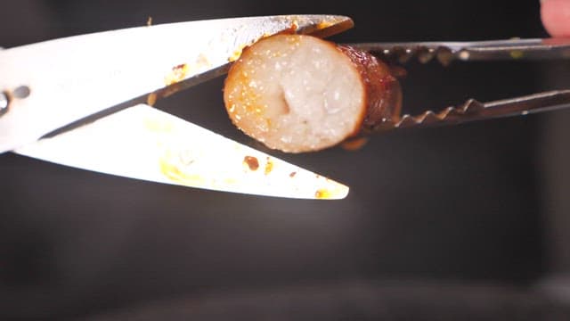 Grilled beef large intestines on top of seasoned grilled chicken feet