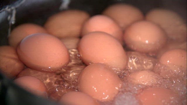 Eggs boiling in a pot of water