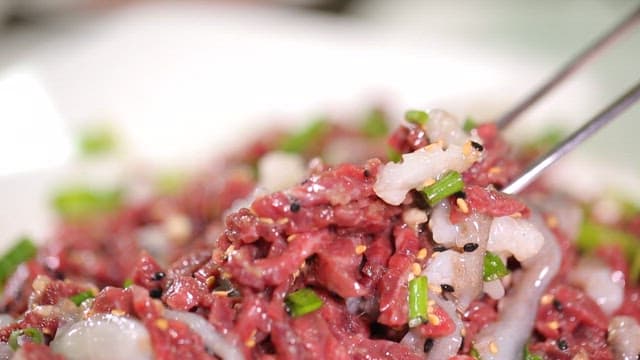 Chopstickful of fresh sliced octopus and beef tartare