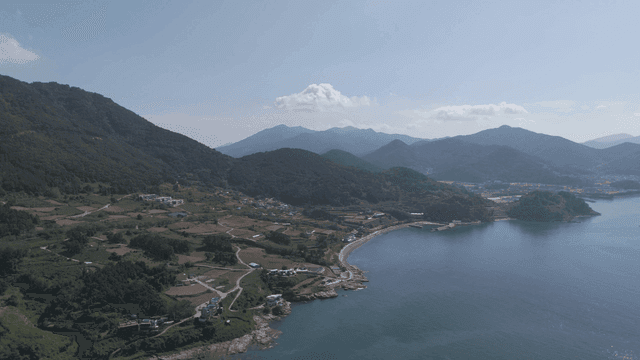 Coastal village with mountains and sea