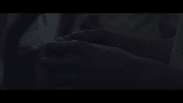 Hand covered with white powder in dark room