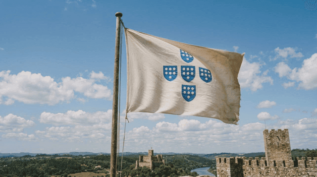 Estado Novo flag fluttering near historic castle