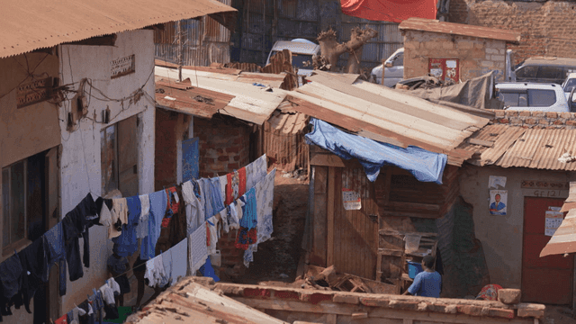 Busy slum neighborhood with laundry hanging out to dry