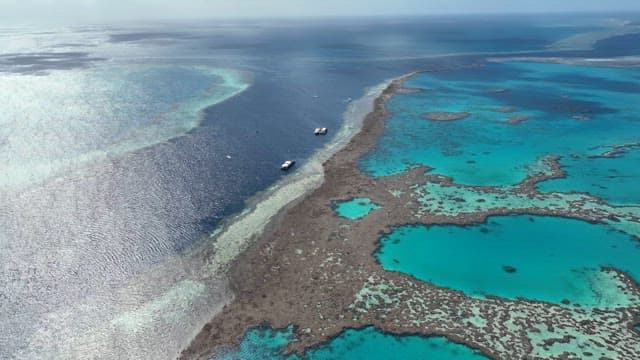 Boat Floating on Clear Blue Sea