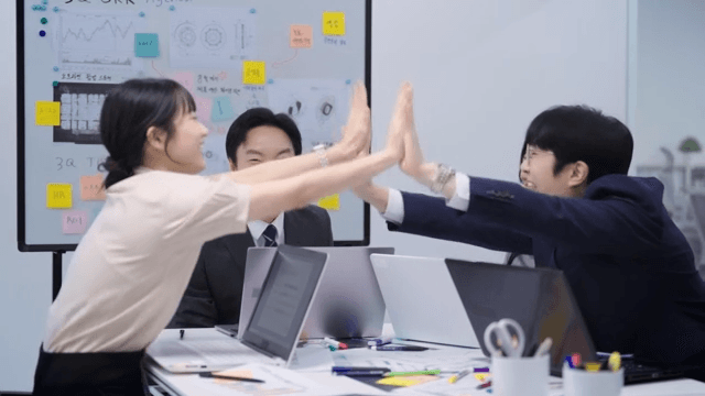 Team celebrating after confirming a deal over the phone