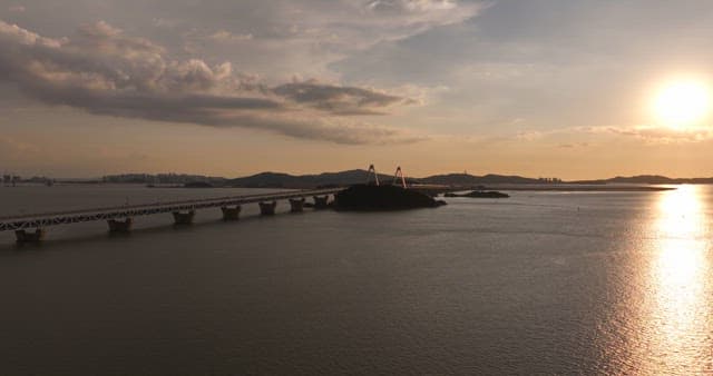 Bridge over a calm sea at sunset