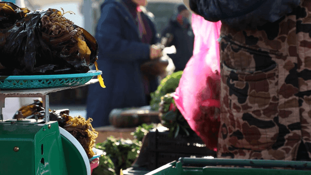 Outdoor market with fresh produce and people