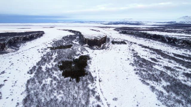 Snow-covered landscape with cliffs