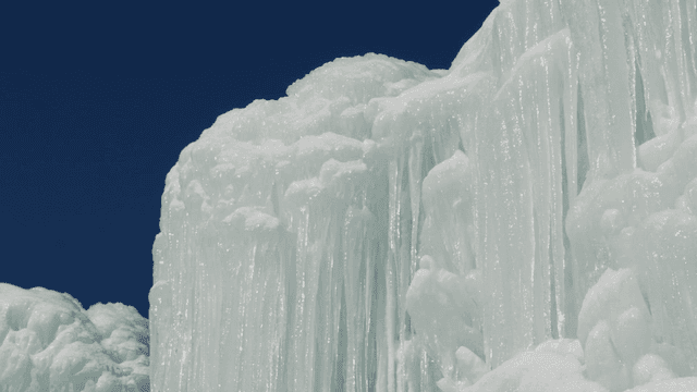 Frozen waterfall under clear sky