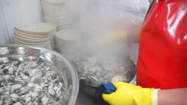 Fresh oysters topping kalguksu noodles in kitchen