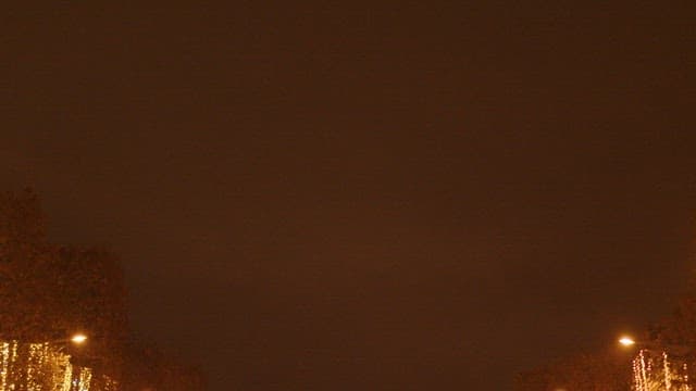 Nighttime city street decorated with festive lights