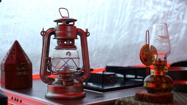 Lanterns and a stove on a rainy day in a tent