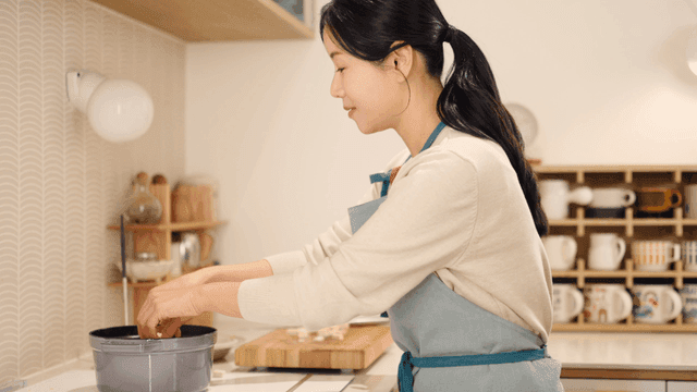 Woman preparing ingredients in a kitchen
