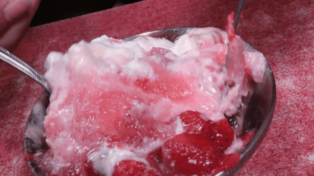 Mixing shaved ice with a spoon