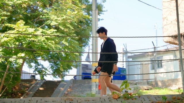 Two people jogging under a bridge