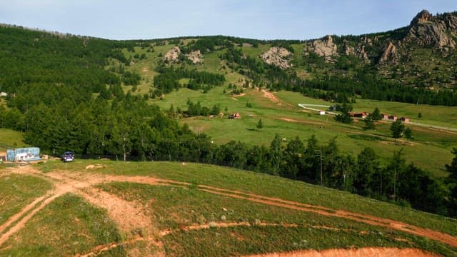 Vast green landscape with hills and trees