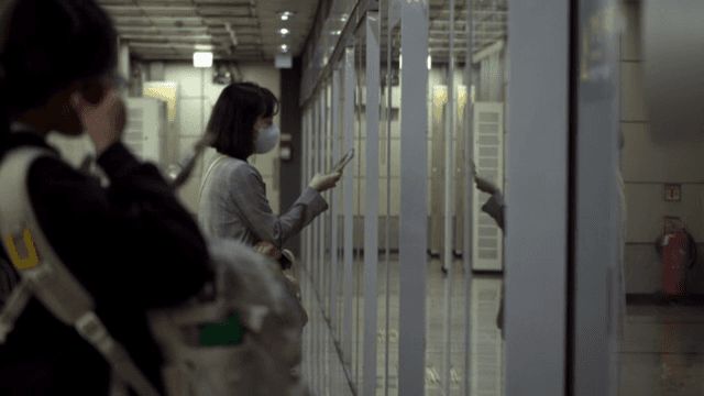 People waiting for the subway while looking at their smartphones