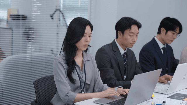 People working on laptops in an office